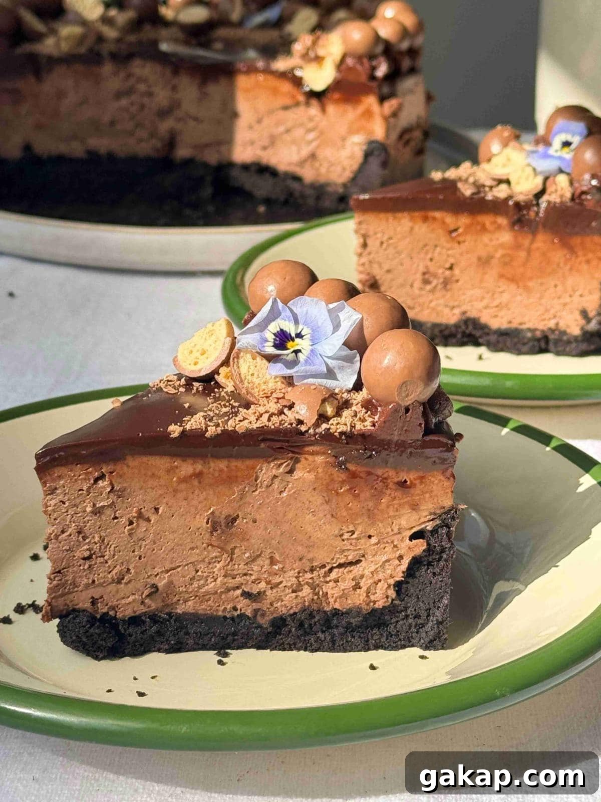 slice of no-bake chocolate cheesecake on a white plate with green rim.
