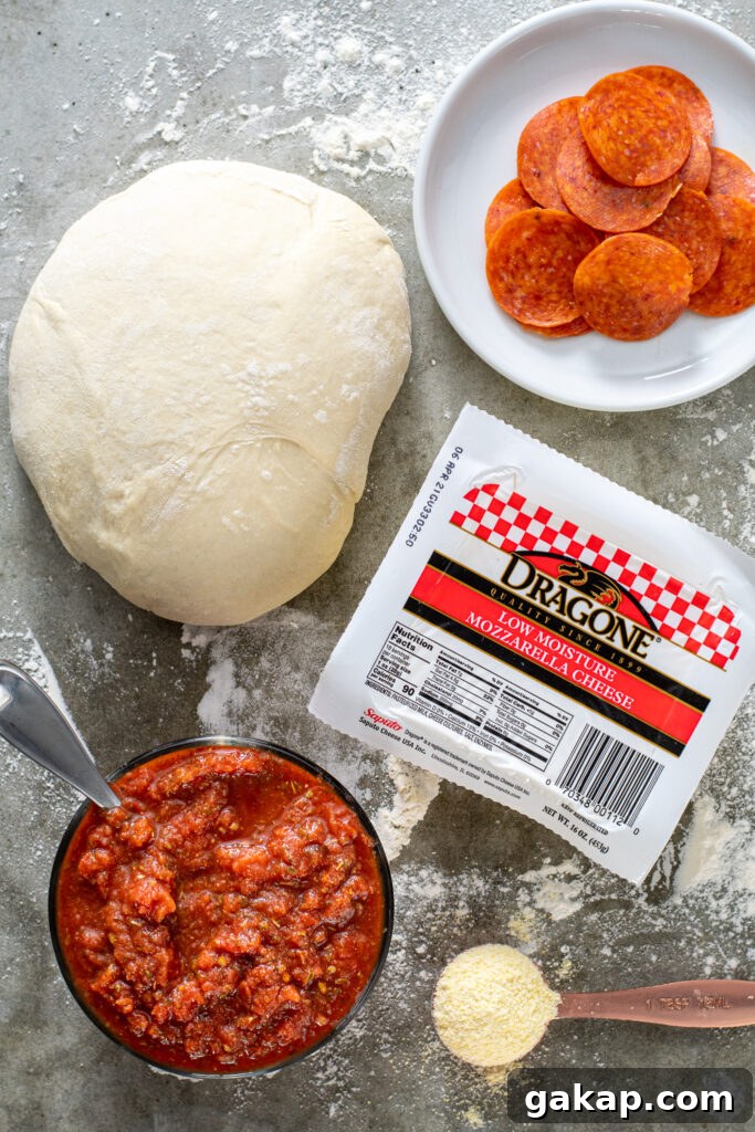 Ingredients laid out for making homemade pizza on a countertop.