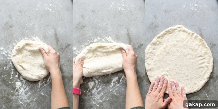Prepping the pizza dough by stretching it out into a circle.