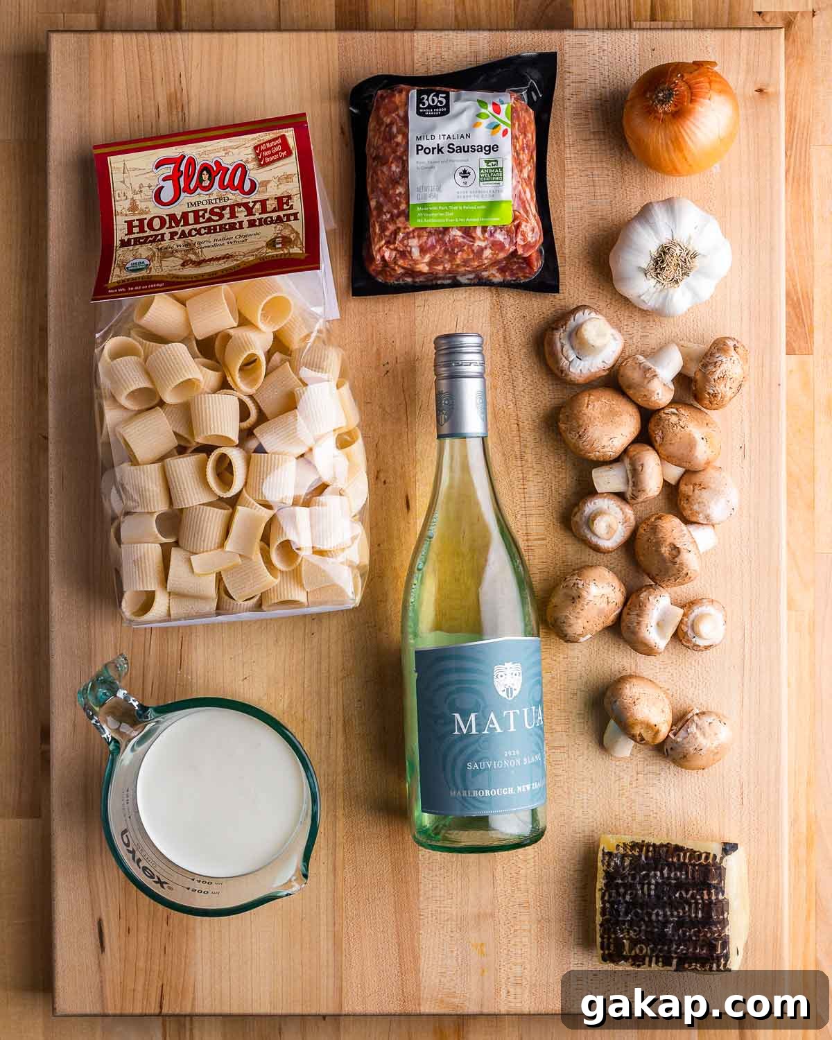 Norcia-Style Sausage Pasta (Pasta alla Norcina) 3 Ingredients shown: paccheri pasta, sausage, onion, garlic, mushrooms, cream, white wine, and Pecorino Romano.