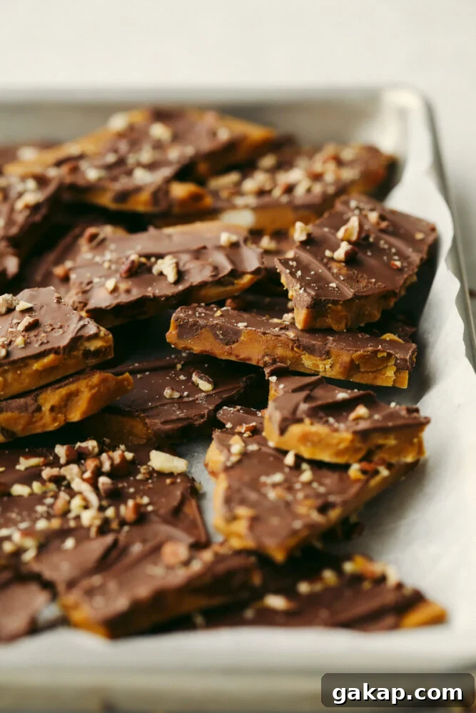 Homemade toffee is super simple with no candy thermometer required! This buttery chocolate treat is a must-make recipe this holiday season! Toffee broken up into multiple pieces.