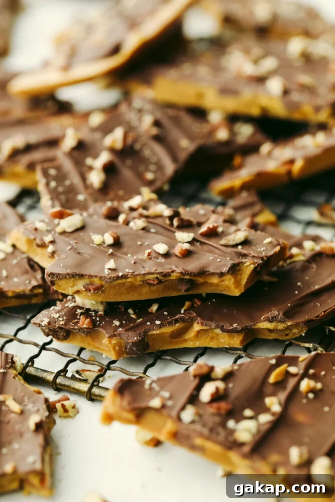 Homemade toffee is super simple with no candy thermometer required! This buttery chocolate treat is a must-make recipe this holiday season! Closeup of broken toffee pieces.