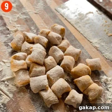 Homemade Pumpkin Gnocchi Recipe with Sage Butter 11 Homemade pumpkin gnocchi on a cutting board.