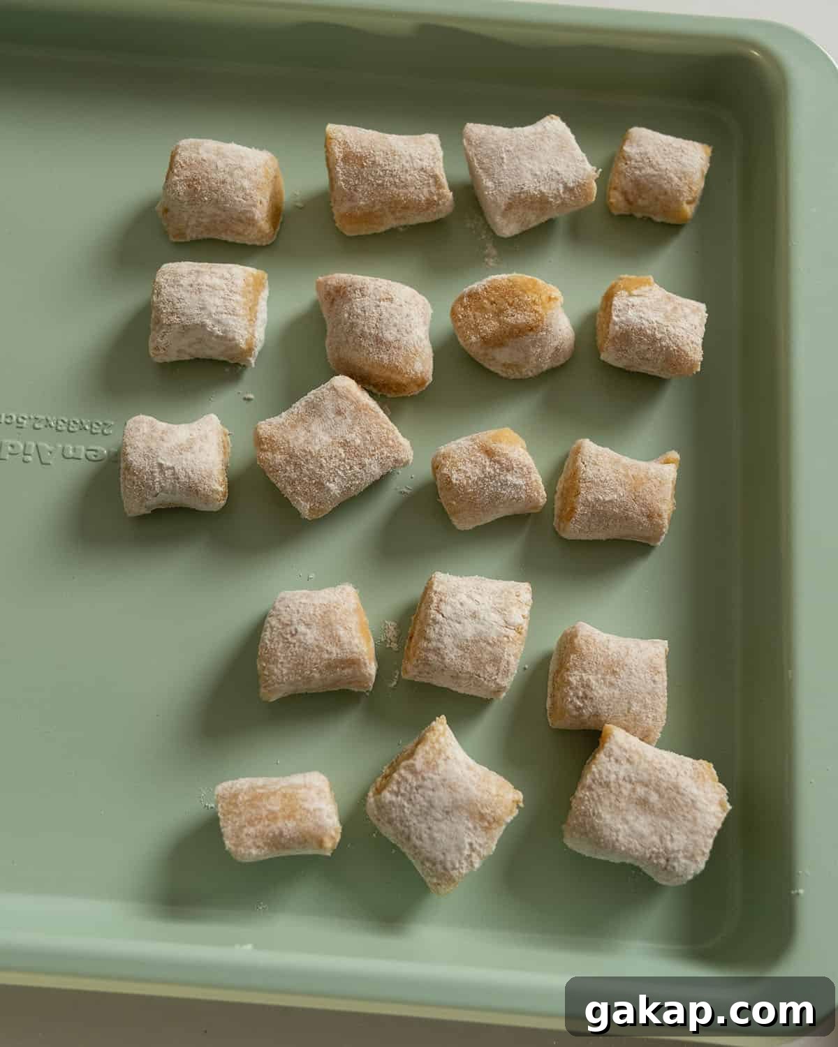 Homemade Pumpkin Gnocchi Recipe with Sage Butter 12 Gnocchi separated out on a baking tray.