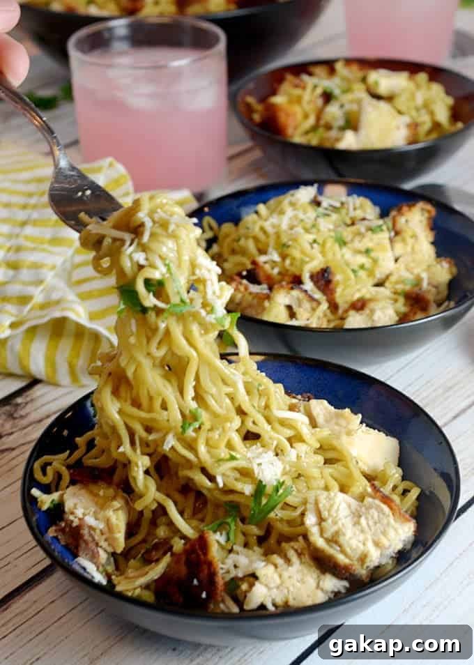 three bowls of ramen noodles with glass of pink lemonade.