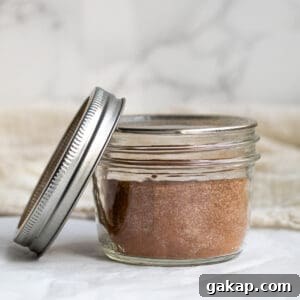 cinnamon sugar in a mason jar with the lid next to it.