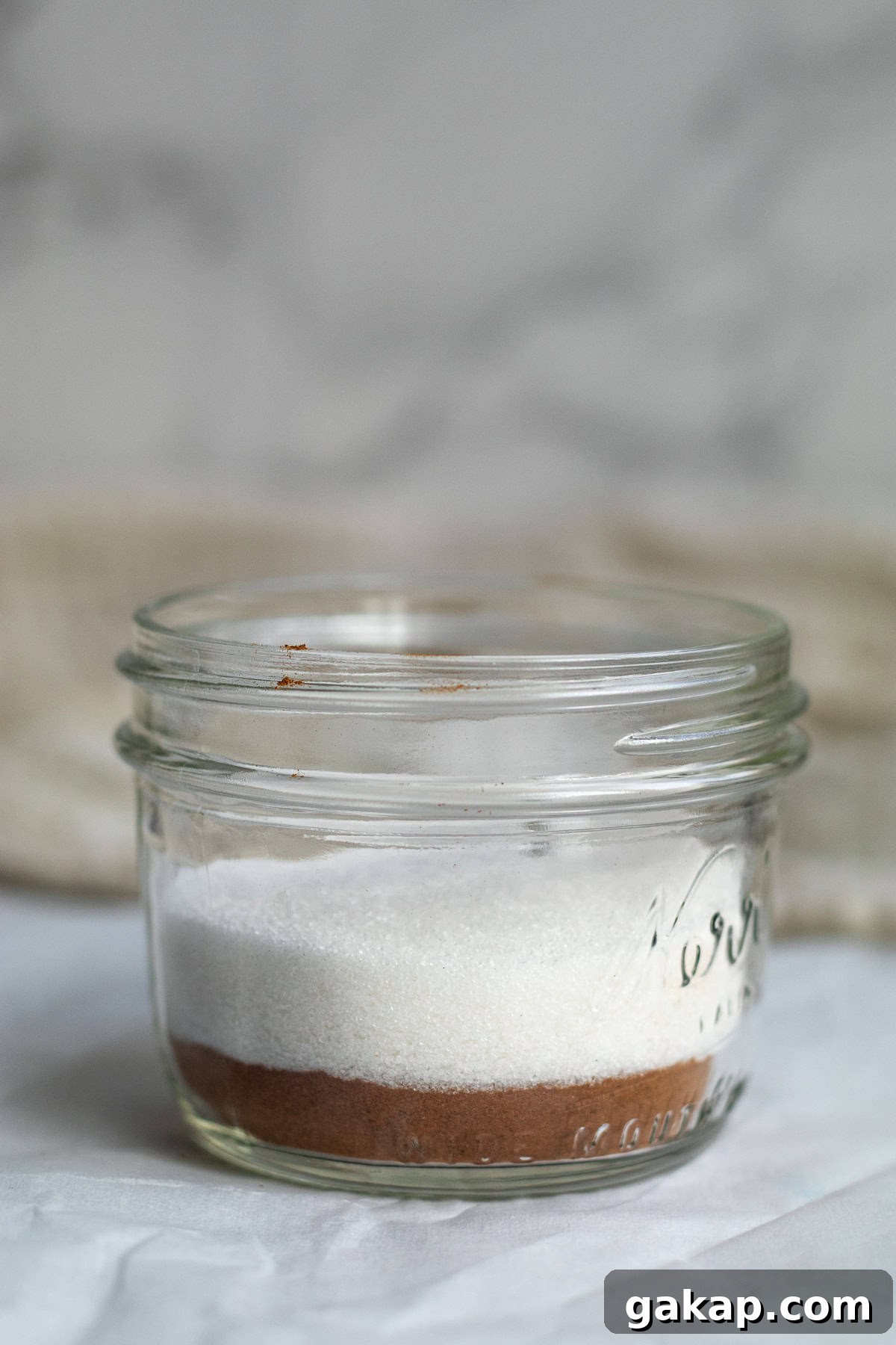 sugar on top of cinnamon in a mason jar