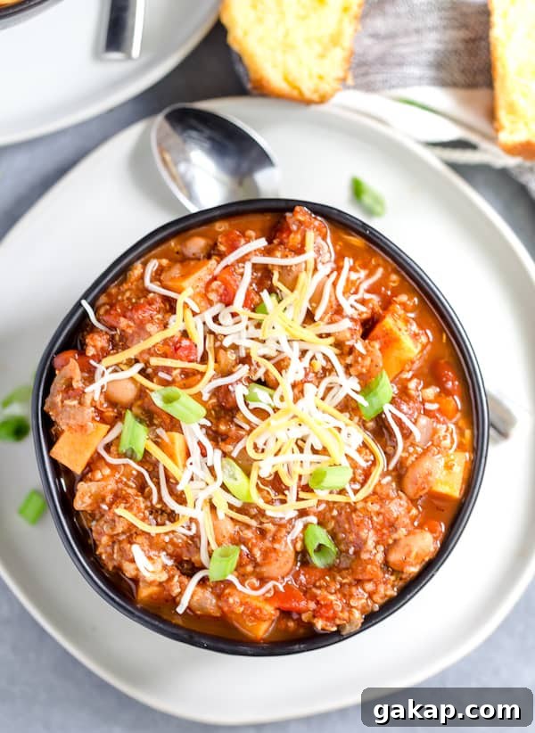 Instant Pot Turkey and Quinoa Chili Recipe 2 Instant Pot Turkey Quinoa Chili Overhead Shot on the Dish Served in a Dark Bowl with a Spoon Next to It