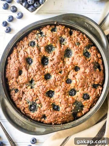 Blueberry breakfast cake baked in a round cake pan.