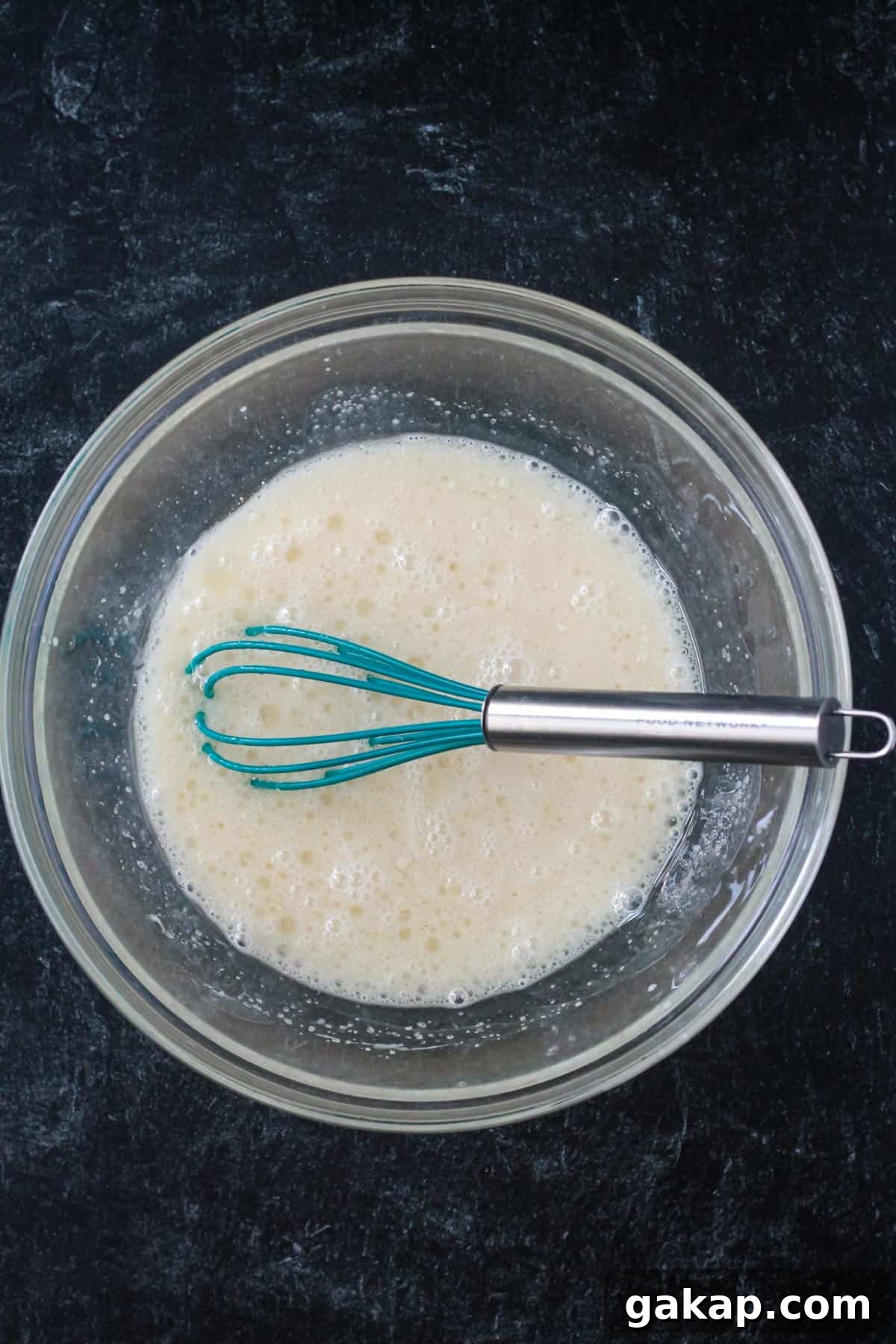 Wet ingredients whisked in a mixing bowl.