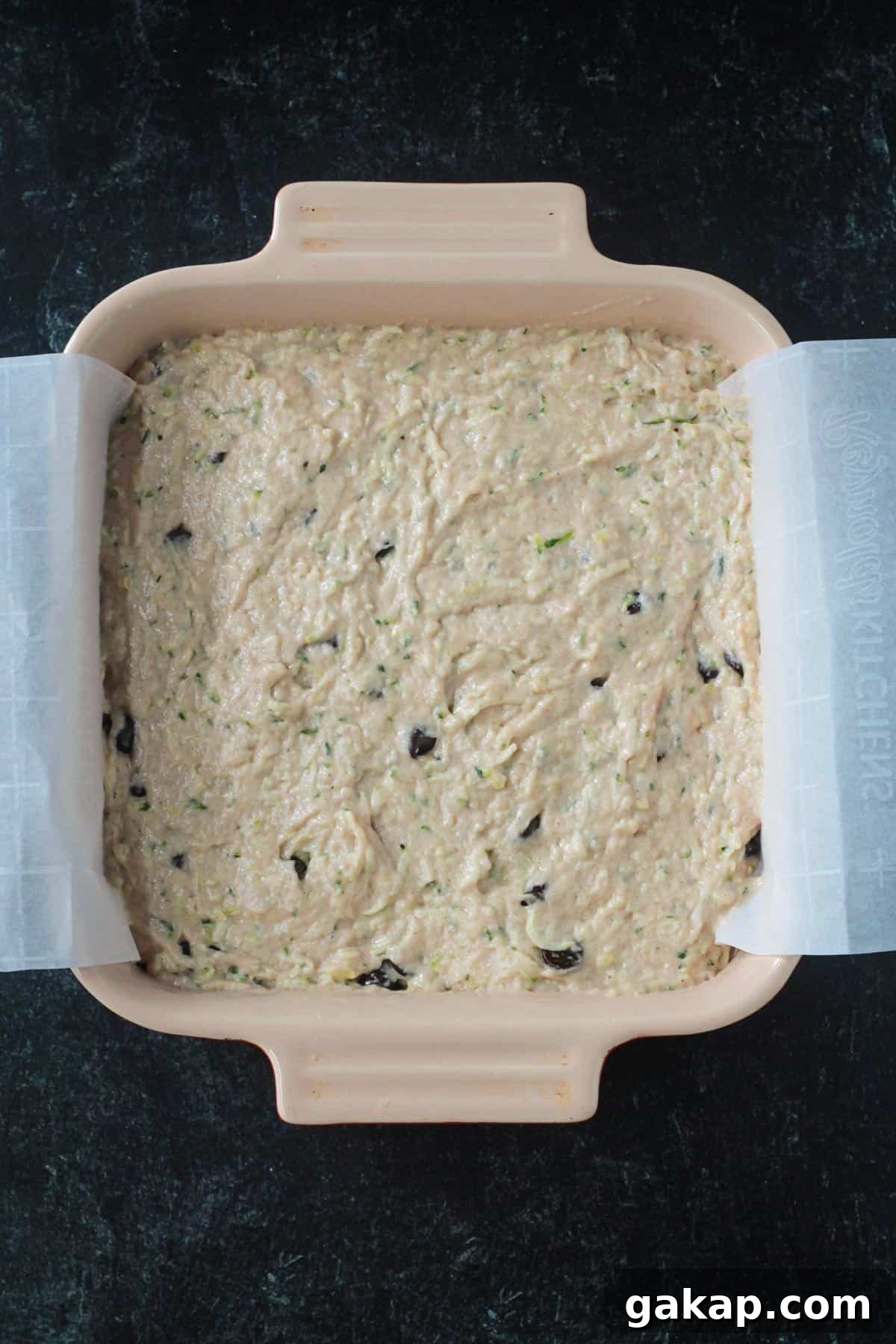 Cake batter in a square baking dish.