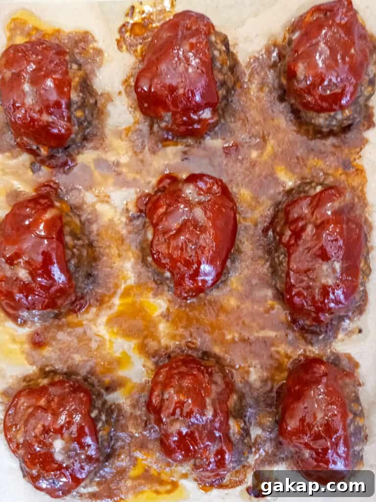 mini baked cheddar meatloaves on a baking tray