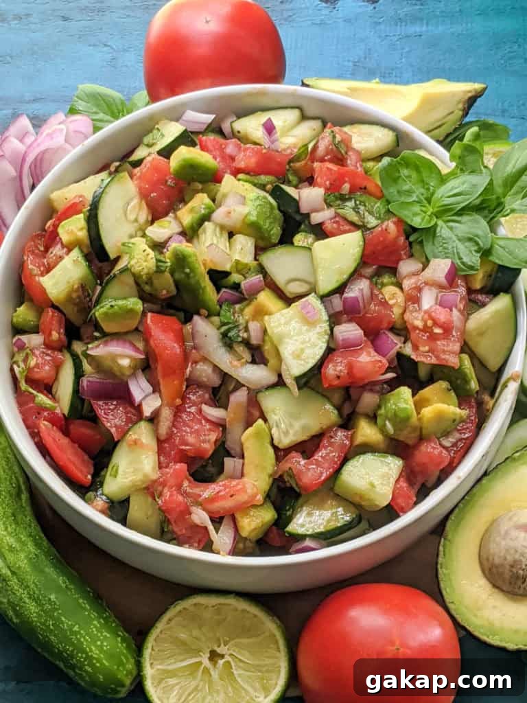 Delicious side salad packed with fresh cucumbers, tomatoes, avocado, basil, and more! Paleo, Whole30, and Vegan friendly as well as dairy-free, gluten-free, and sugar-free. Easy, satisfying, and only 8 ingredients. 