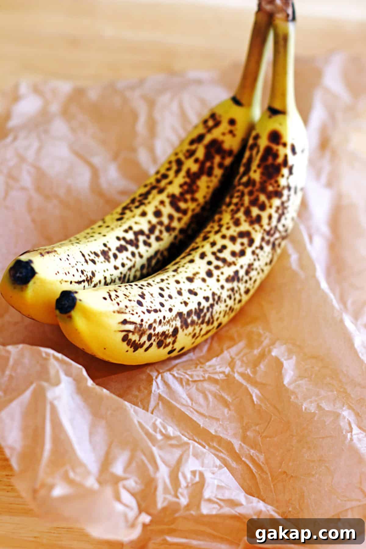 Ripened bananas sitting on brown parchment paper