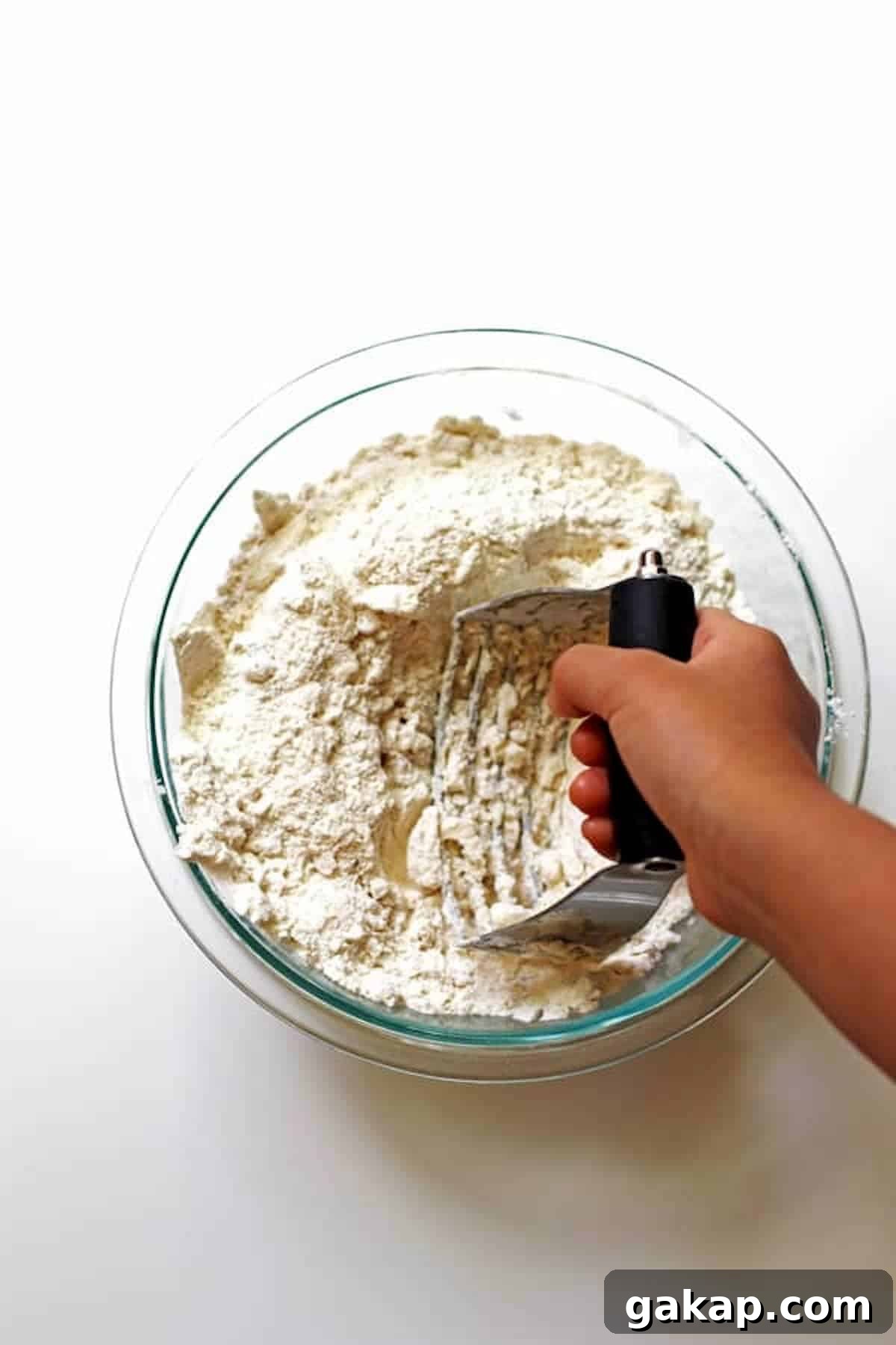 Combining flour with other dry ingredients with a pastry blender