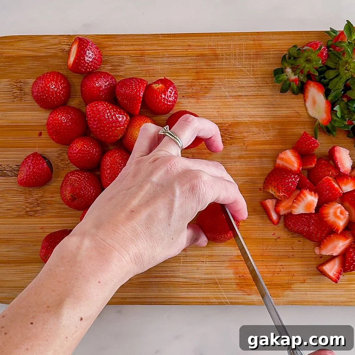 Chopping strawberries.