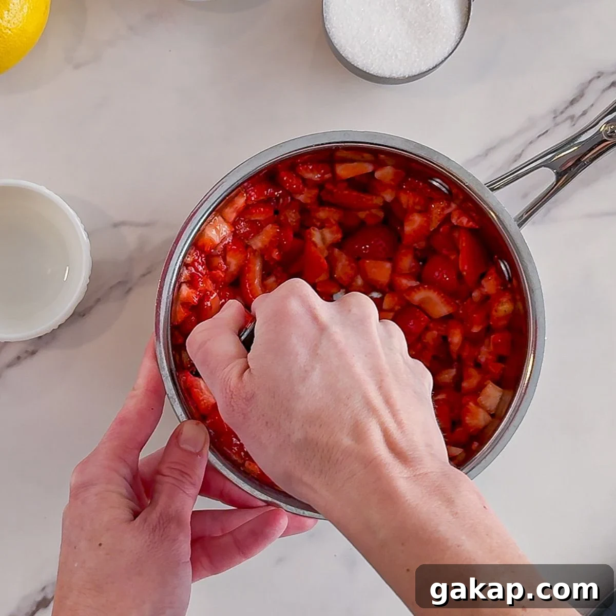 Mashing strawberries.