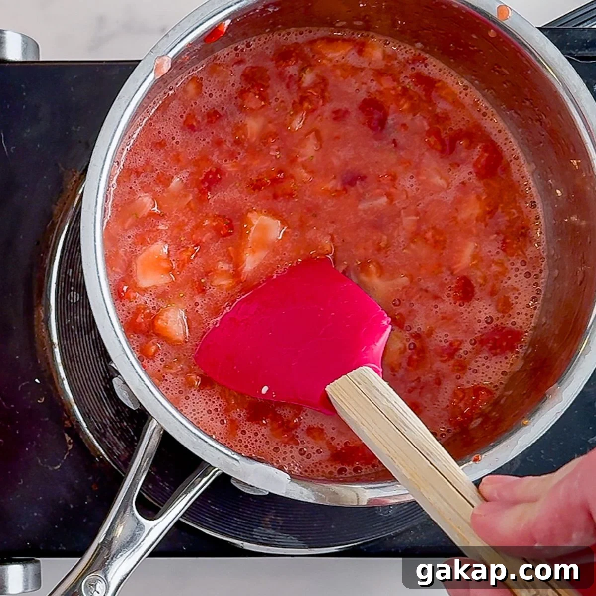Bringing the strawberries in a pot to a boil.