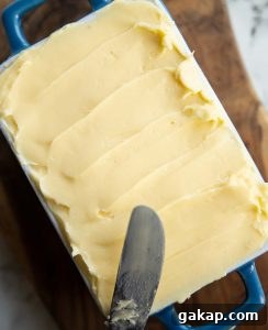overhead shot of butter in small dish with knife resting on it