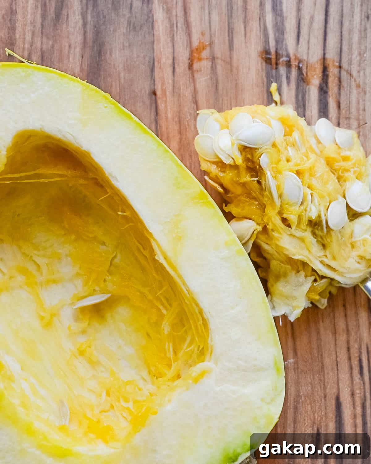 Scooping the seeds from the squash.