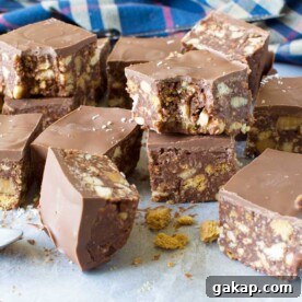 Squares of hedgehog slice piled up and around each other on baking paper
