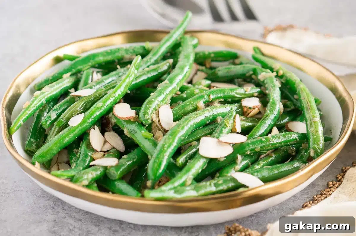 green beans with almonds in a white bowl