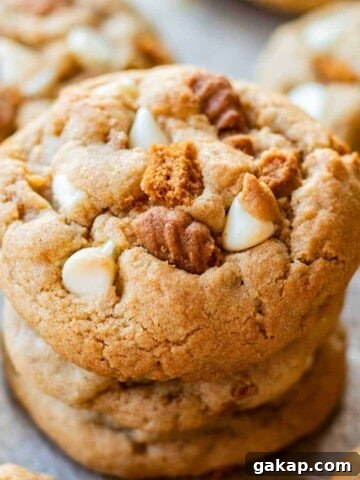 Baked white chocolate biscoff cookie stack of 3 on metal baking pan.
