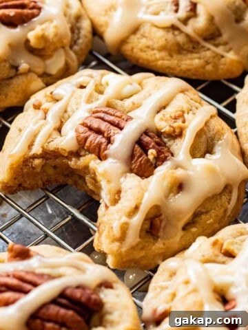 Baked Maple Cookies on metal pan with bite out of one.
