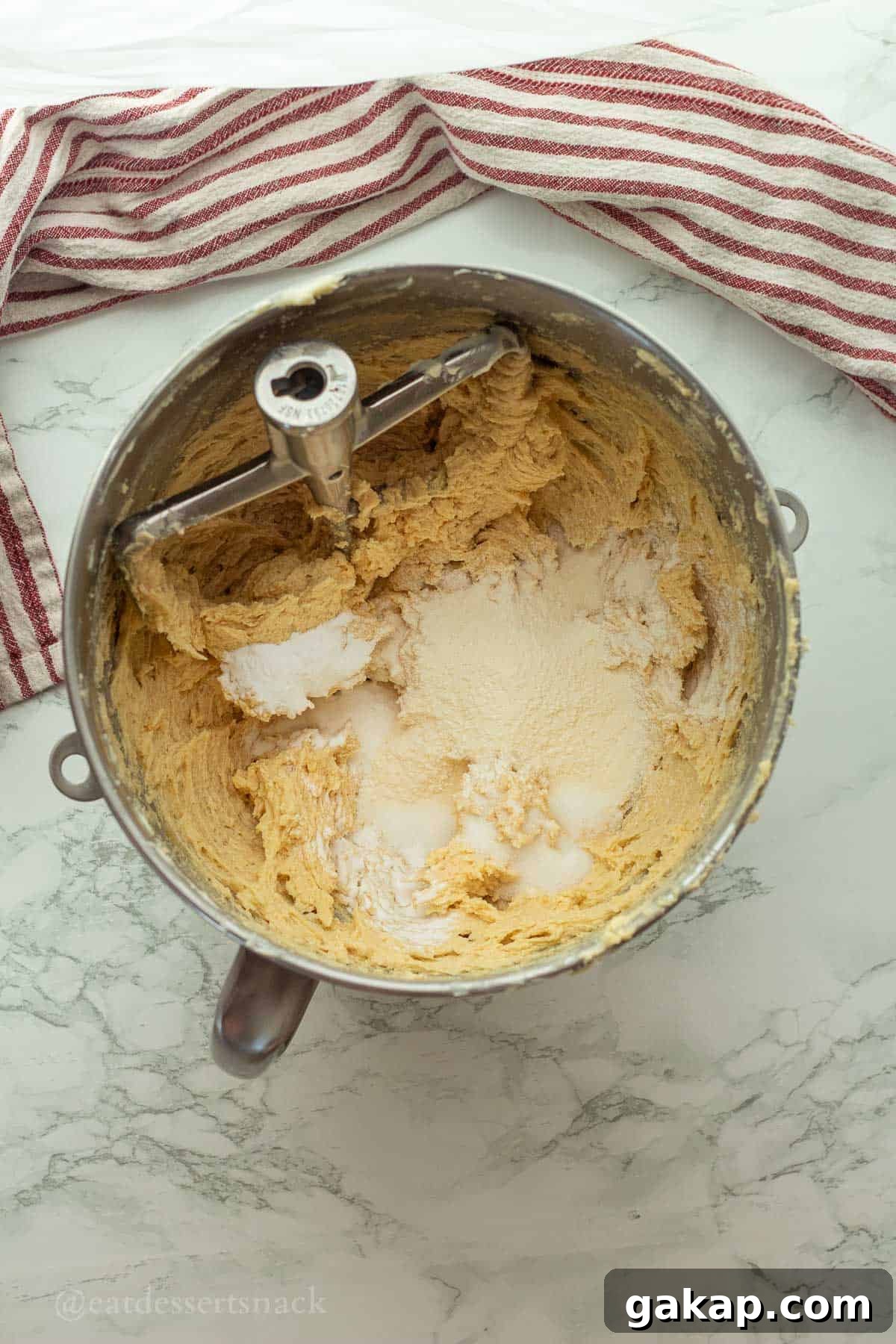 Vanilla pudding mix in cookie dough in mixing bowl.
