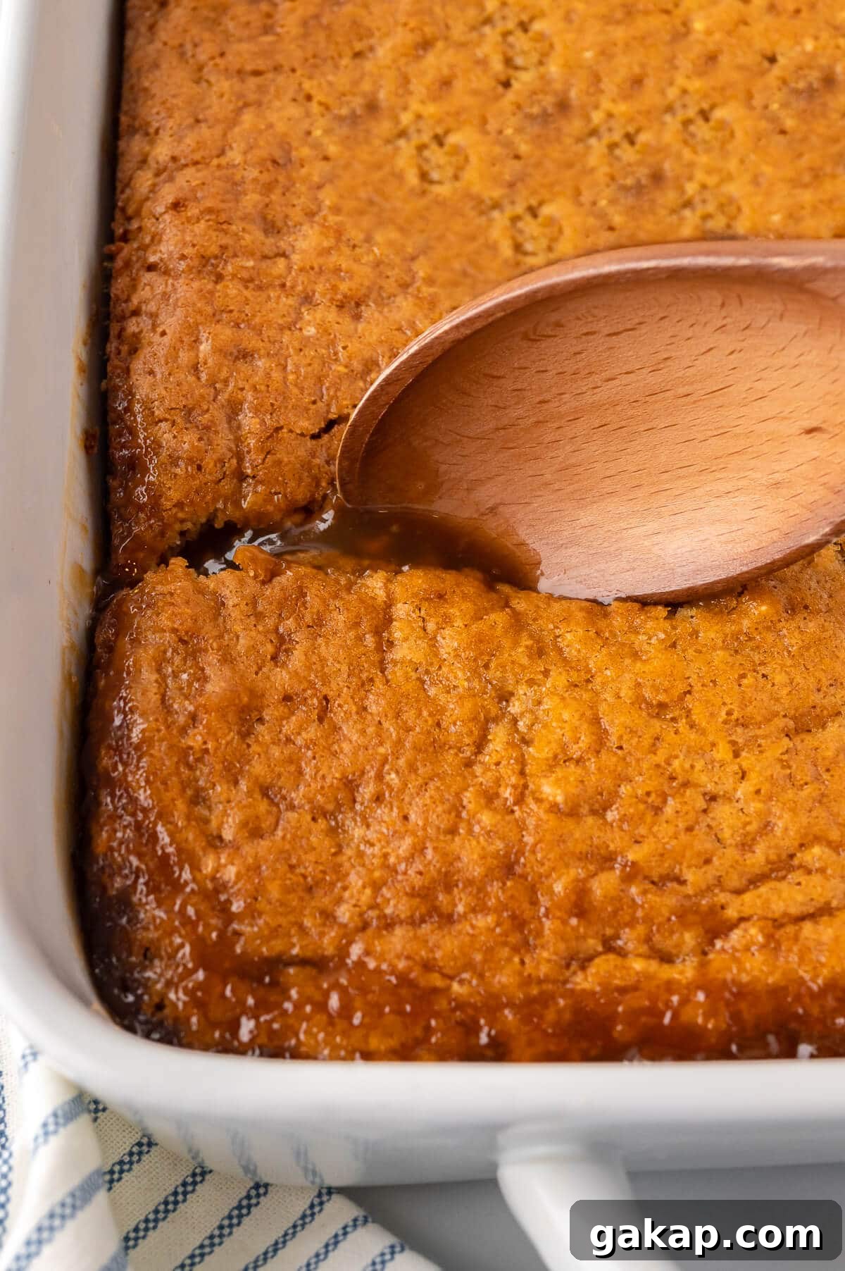 Half hour pudding in a pan with a wooden spoon.