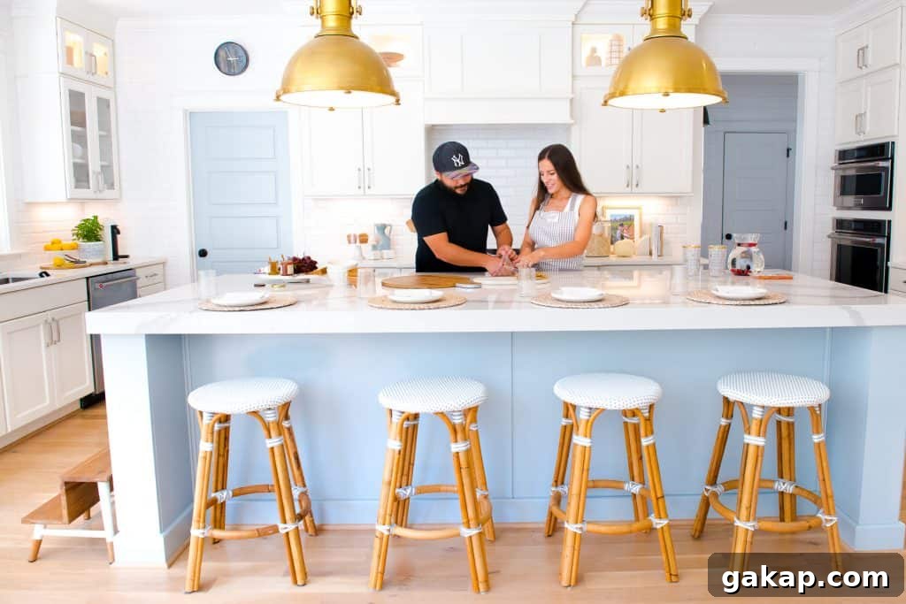 man and woman putting together a cheese plate at kitchen island, 4 kid friendly counter stools lined up