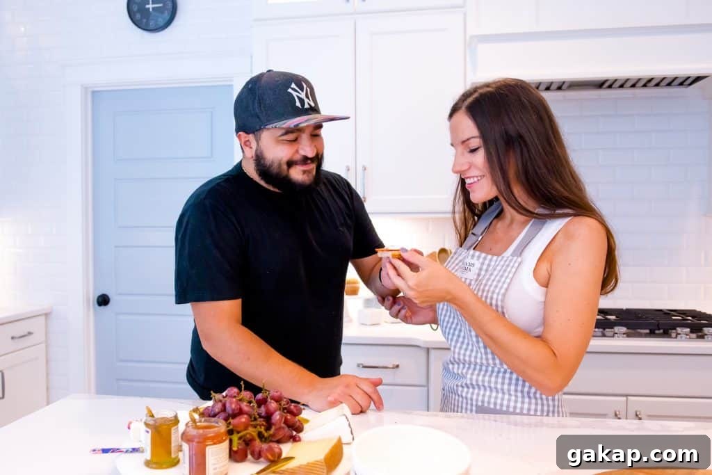 man and woman making a plate of food in kitchen