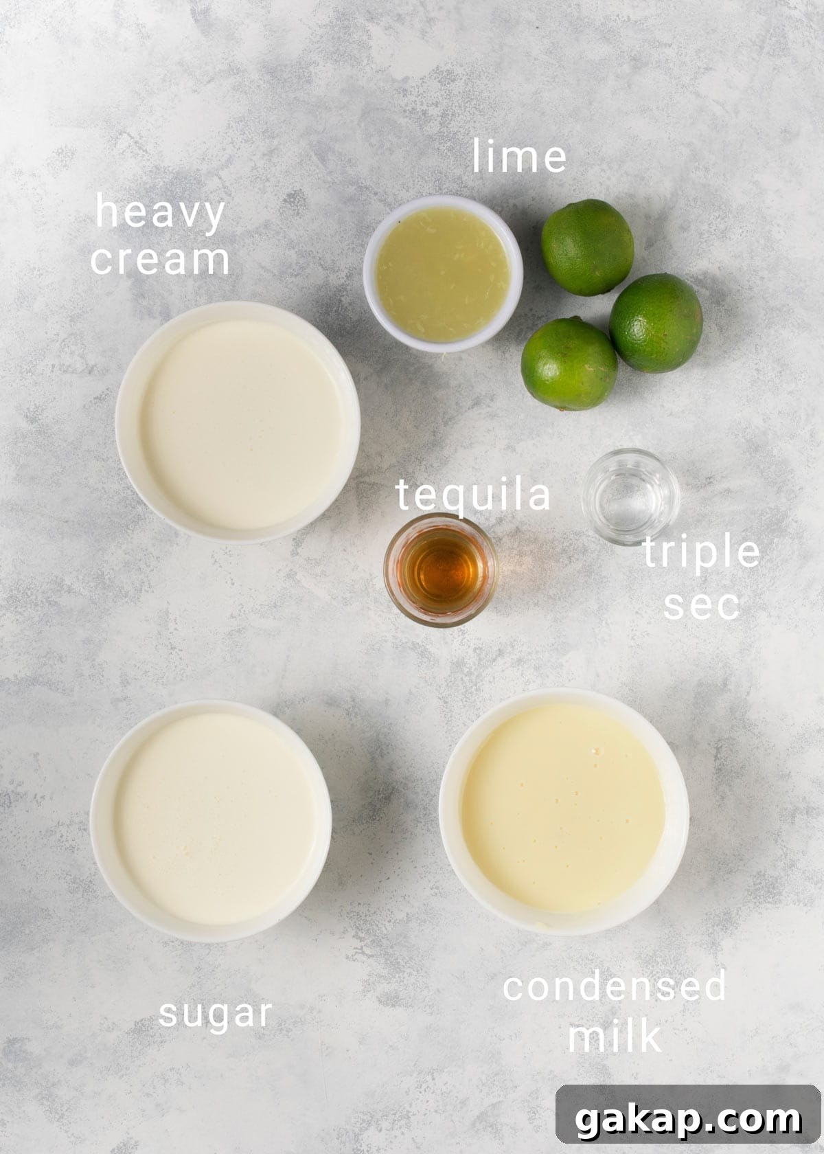 No-Churn Margarita Ice Cream: Creamy Lime & Tequila Recipe 3 Ingredients for margarita ice cream on a counter, including tequila and lime.
