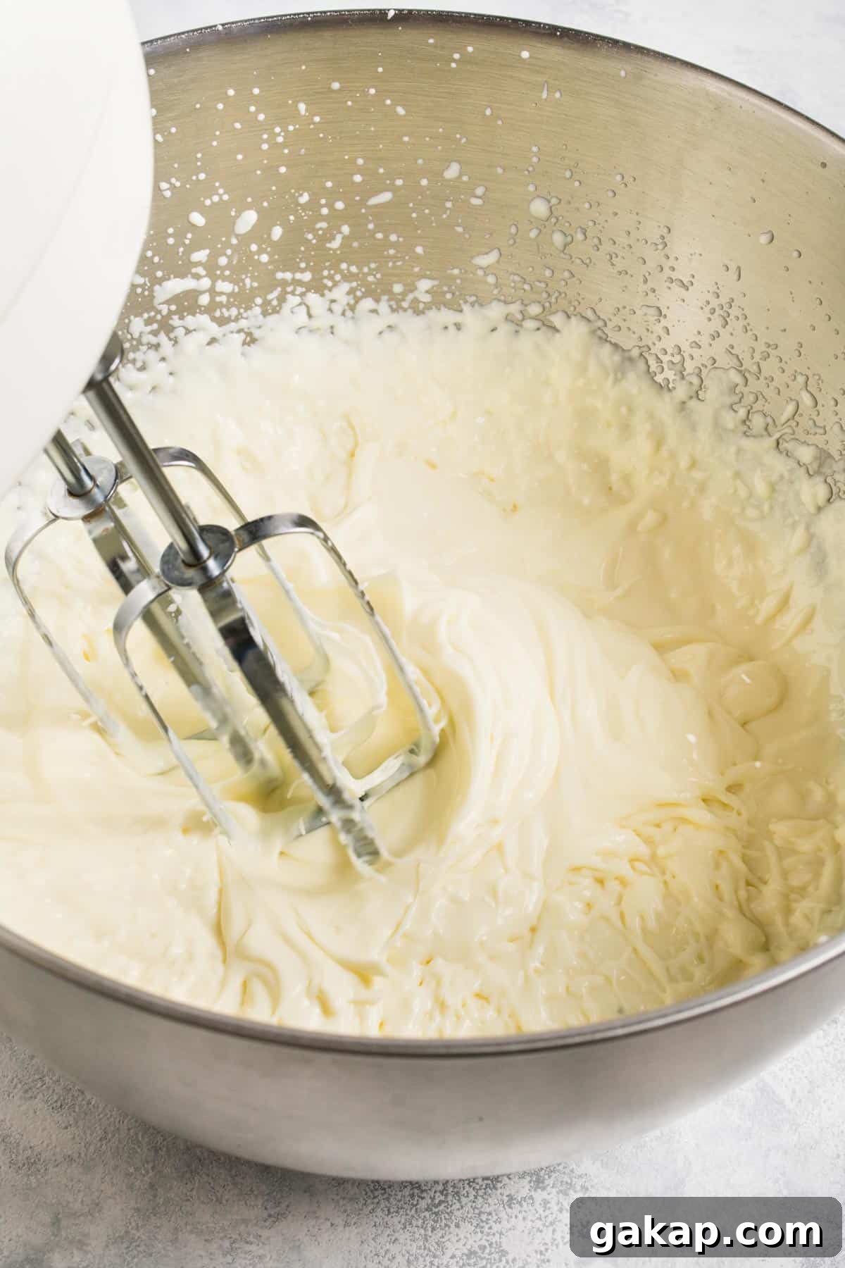 No-Churn Margarita Ice Cream: Creamy Lime & Tequila Recipe 5 Whisking together margarita ice cream ingredients with an electric mixer.