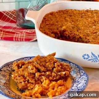 Southern Sweet Potato Casserole with Pecan Streusel 13 Sweet Potato Pecan Casserole in the casserole dish and a plate full of the casserole.