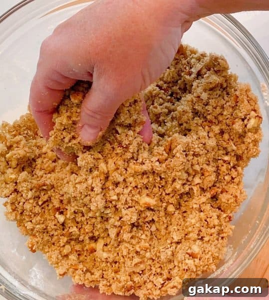 Southern Sweet Potato Casserole with Pecan Streusel 7 Mixing the Crumb topping ingredients with my hands.