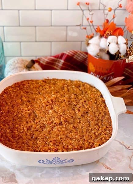 Southern Sweet Potato Casserole with Pecan Streusel 9 Baked Sweet Potato Pecan Casserole pulled right out of the oven in a casserole dish.