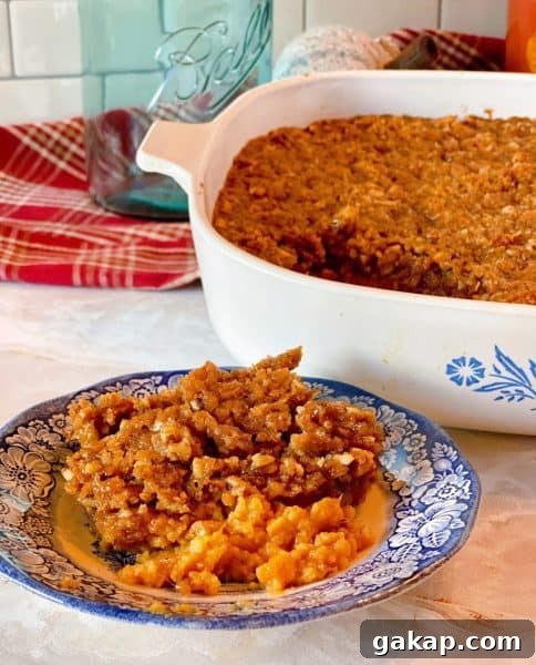Southern Sweet Potato Casserole with Pecan Streusel 10 Sweet Potato Pecan Casserole in the casserole dish and a plate full of the casserole.