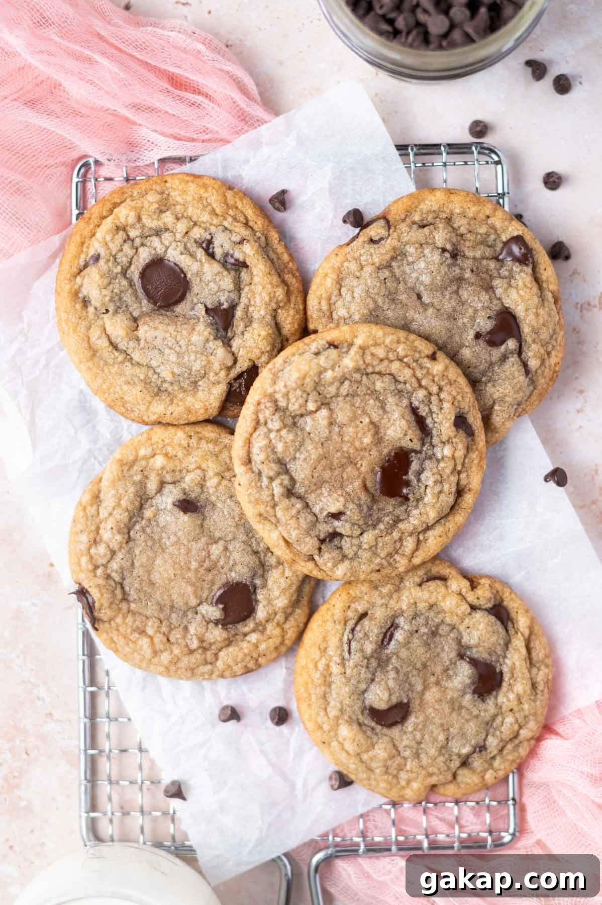 Crispy Thin Chocolate Chip Cookies: Crunchy, Perfectly Baked 3 thin chocolate chip cookies on a parchment lined cooling rack
