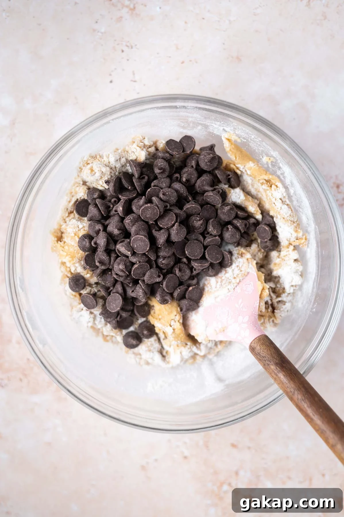 Crispy Thin Chocolate Chip Cookies: Crunchy, Perfectly Baked 8 chocolate chips added to cookie dough in a bowl with a bit of flour still showing in the dough