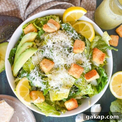 avocado caesar salad in white bowl.