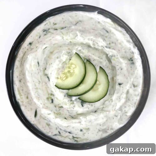 bowl of tzatziki with cucumbers on top