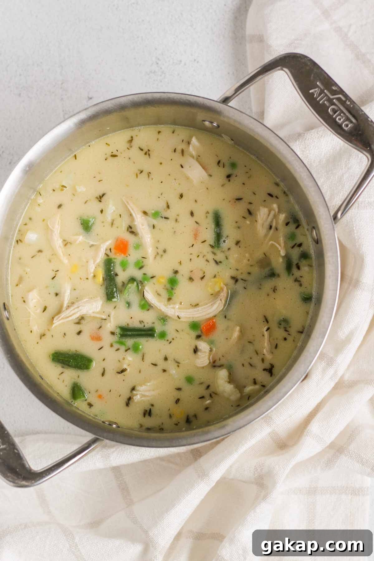 Dairy-Free, Gluten-Free Chicken Pot Pie Soup Recipe 8 Creamy chicken pot pie soup cooking in a stainless steel stock pot.