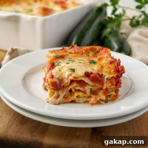 a slice of zucchini lasagna on a white plate.