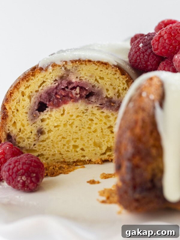 Moist Bundt Spice Cake Made with Cake Mix – Simple Holiday Dessert 9 Looking into the inside of a white chocolate and raspberry cake.
