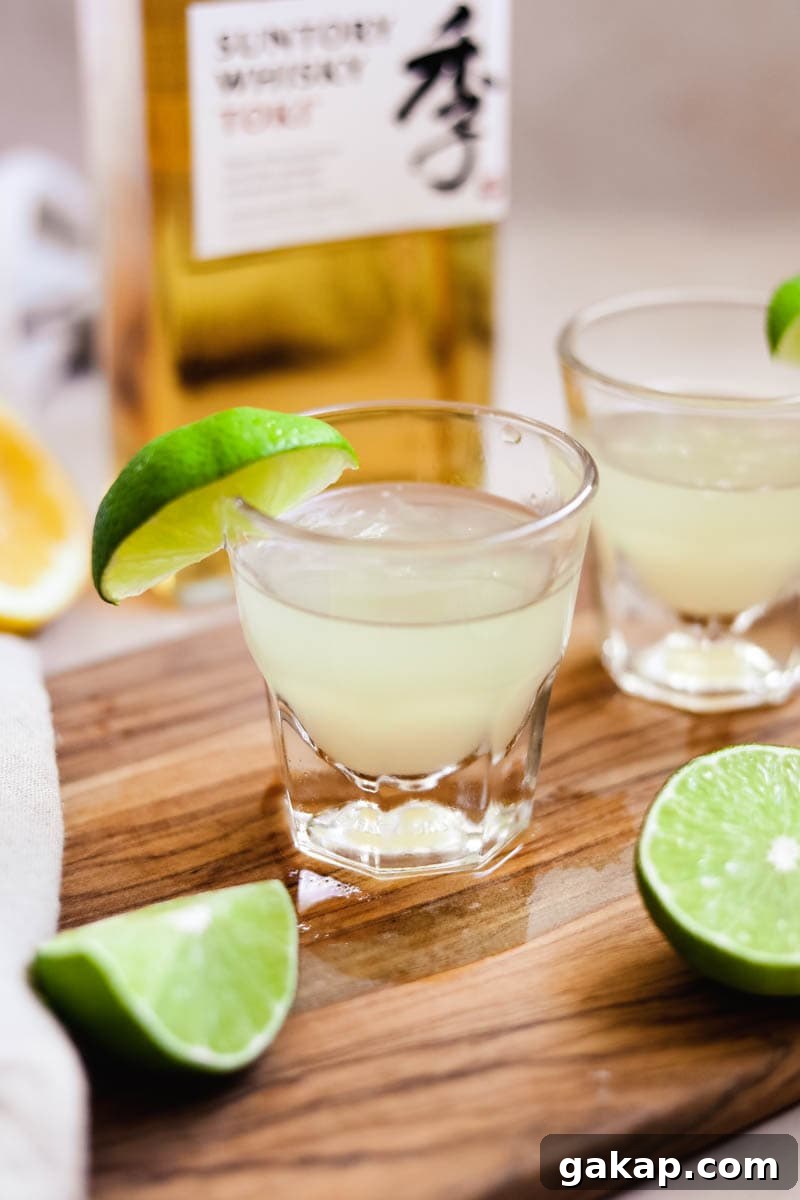 Green tea shot in a shot glass with Japanese whisky and a lime.