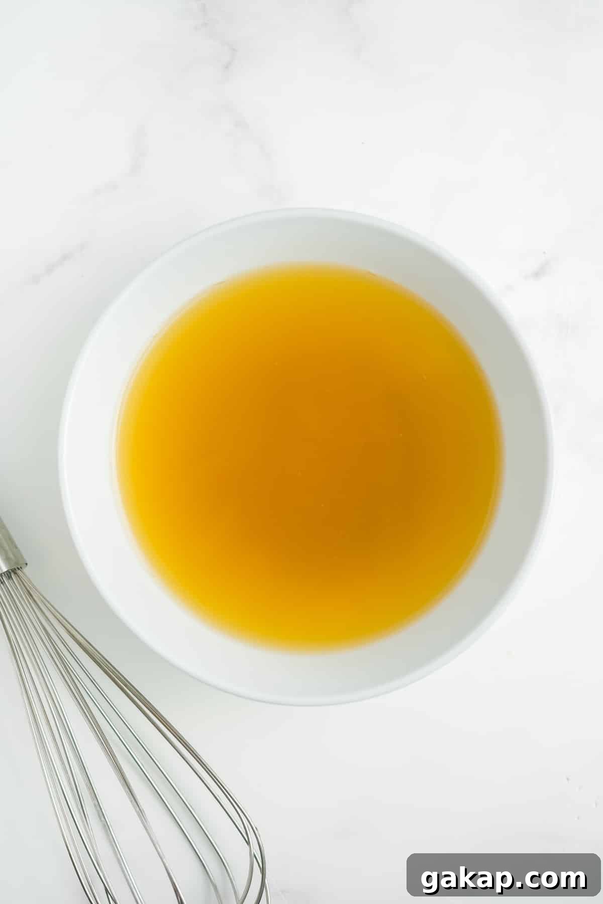 Chicken broth, lime juice, and brown sugar in a bowl.
