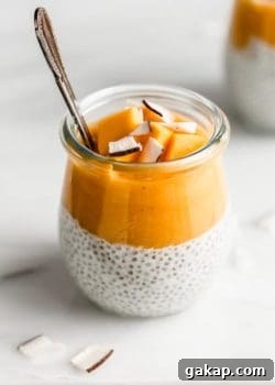 a jar with coconut chia pudding topped with mango puree