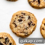 miso shortbread cookies made with brown butter and chocolate chunks on parchment paper with salt on top