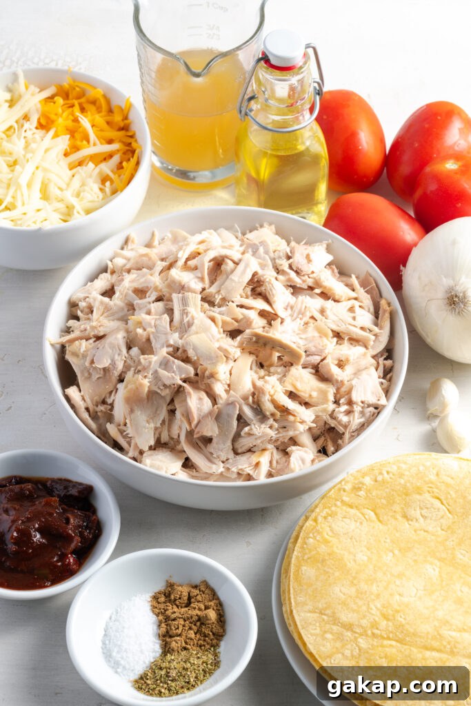 ingredients needed to make homemade crispy chicken tacos measured out on a white table.